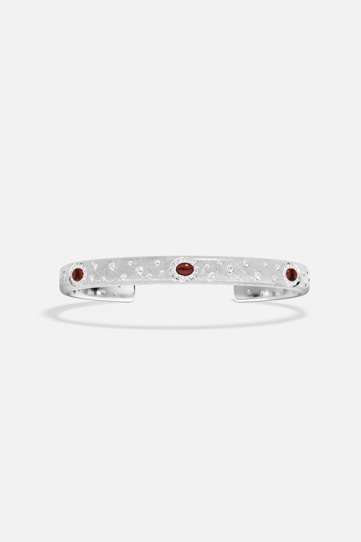 APM Monaco cuff bracelet in rhodium finish, sprinkled with sparkle and deep red accents.