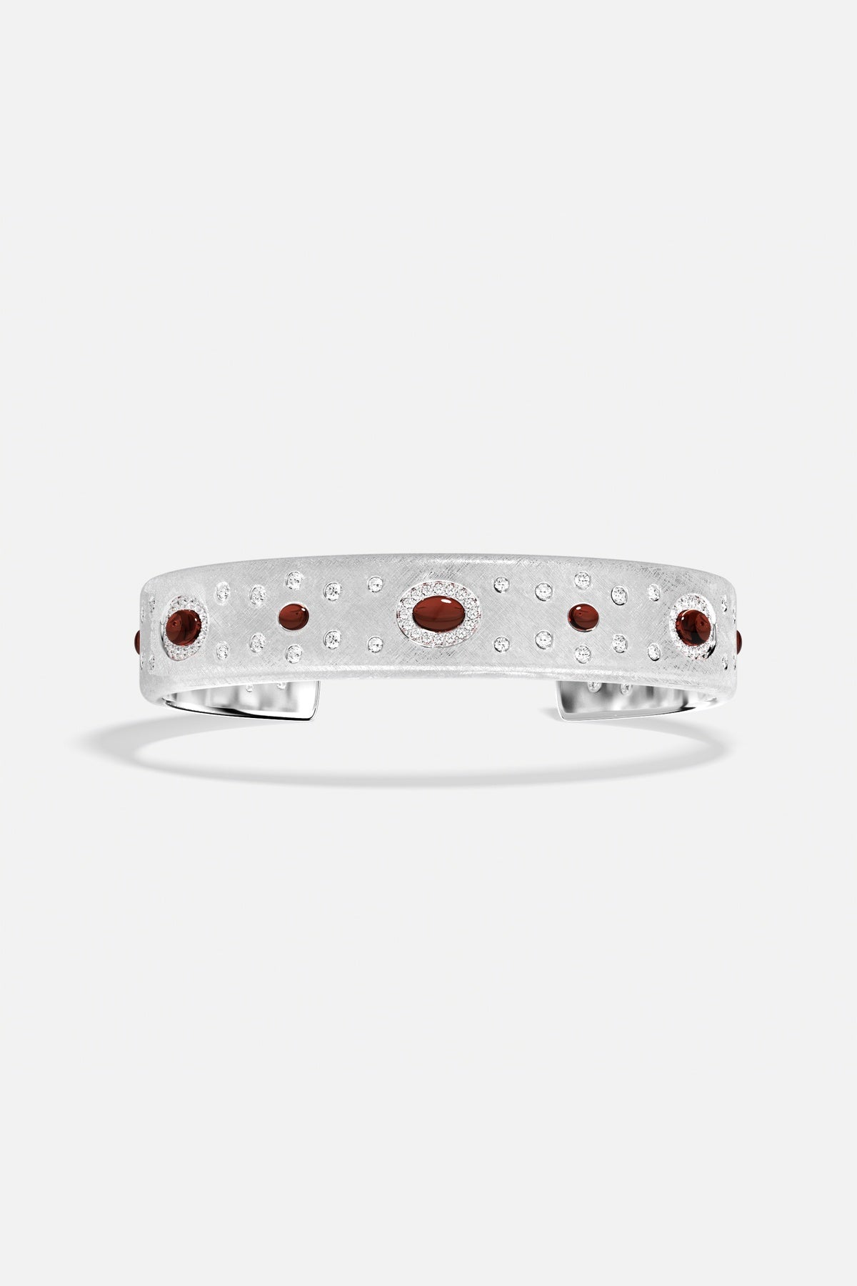 APM Cuff Bracelet, brushed rhodium finish scattered with deep red accents, quietly radiant.