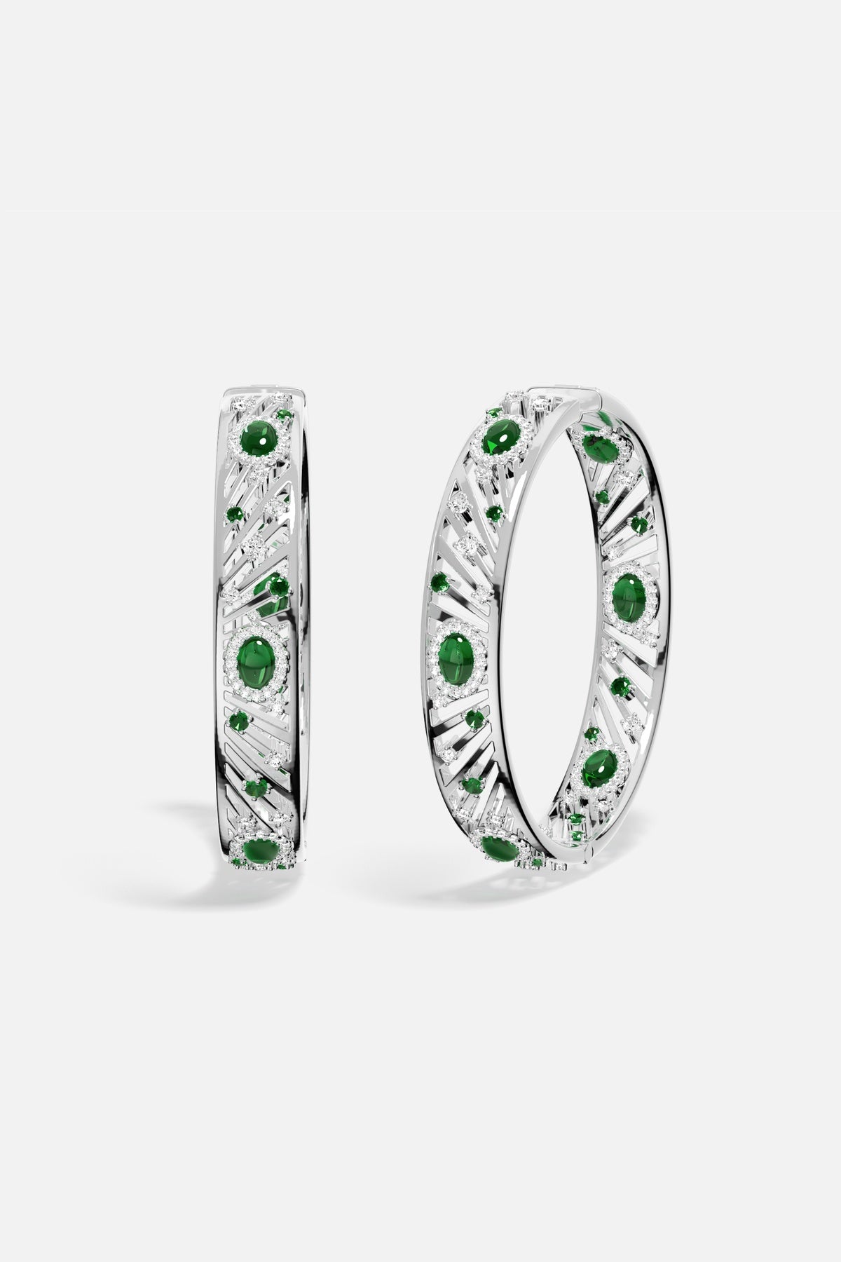 APM Bangles in rhodium finish with emerald green stones, radiant elegance with a modern edge.