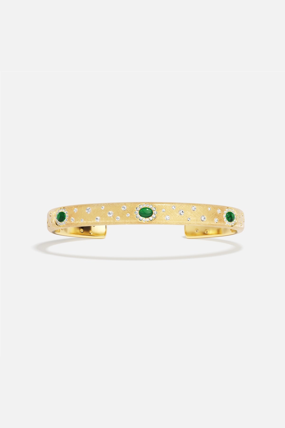 APM Monaco cuff bracelet in golden hues, scattered with emerald green stardust.