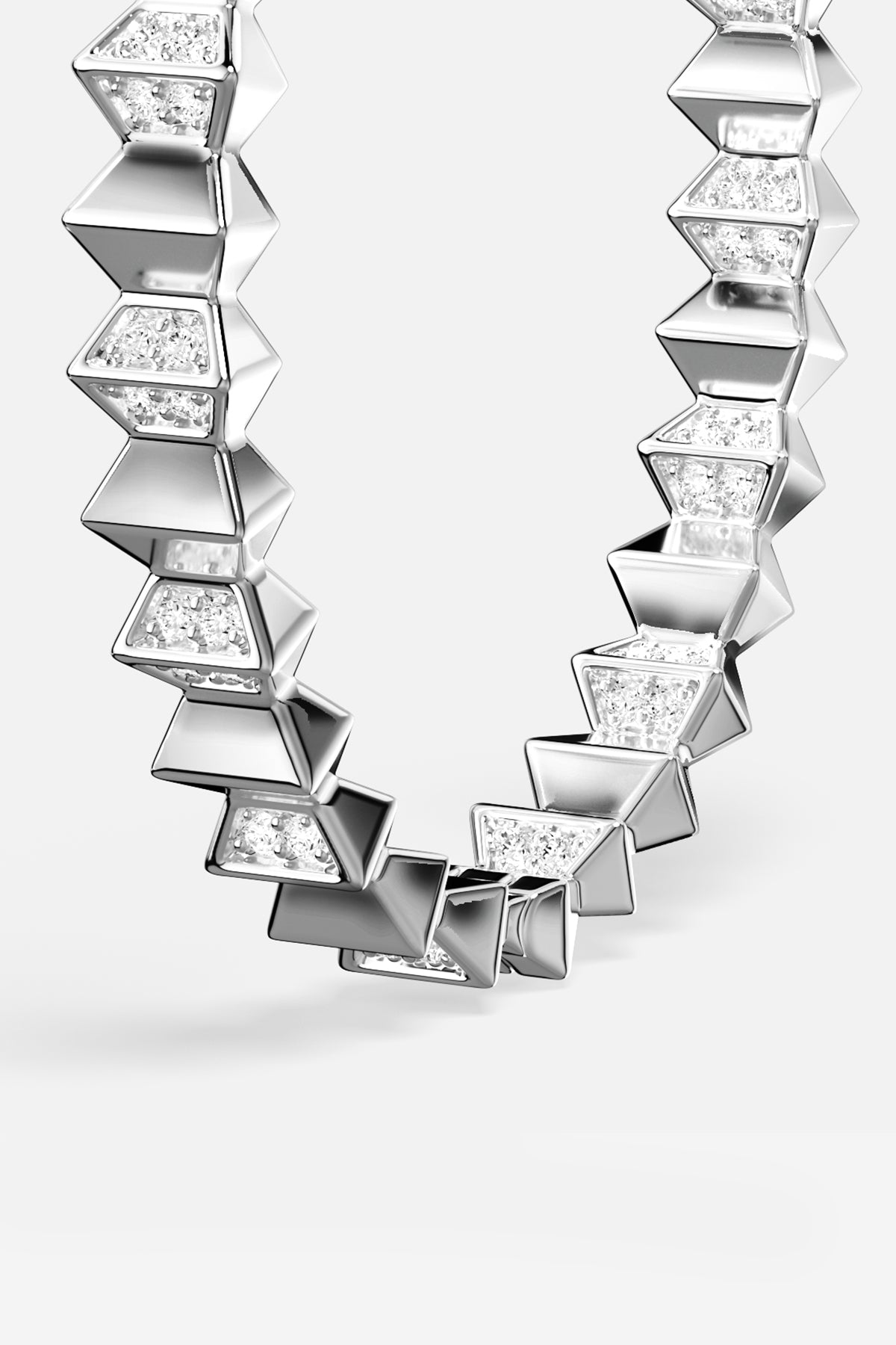 APM hoop earrings in rhodium finish, sculpted geometry with a bold modern edge.