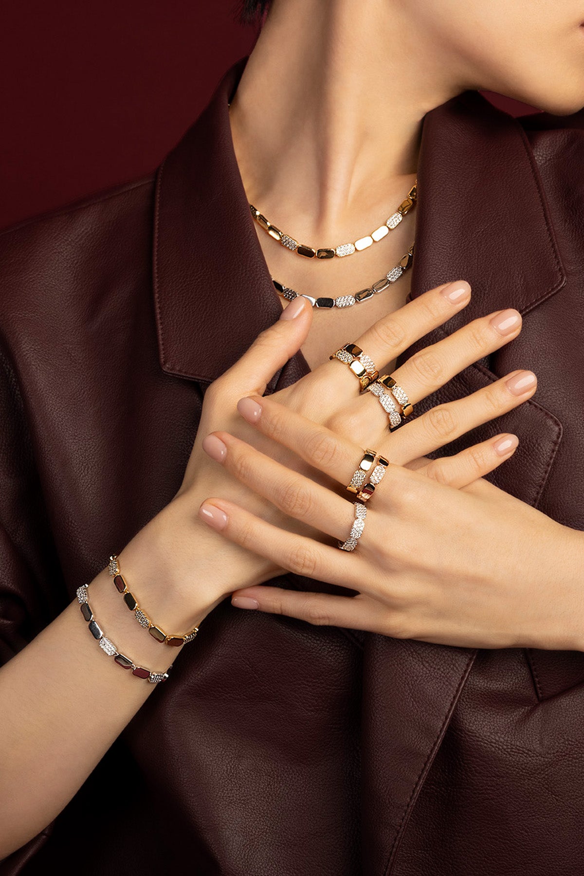 Woman wearing APM Monaco Morse jewelry set, effortless allure in golden and pavé rhythm.