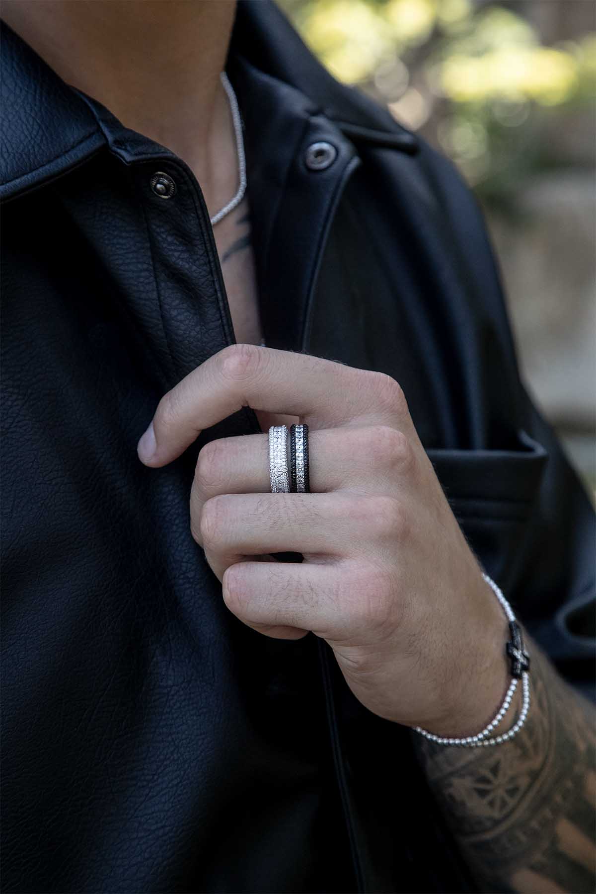 Rings APM Monaco – white pavé ring with clear crystals in a silver-tone finish, worn on a hand with other rings.