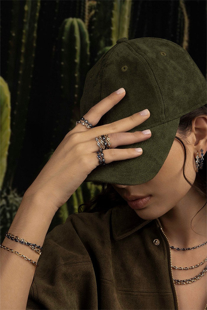APM MONACO Pavé Chain Ring in silver on green background