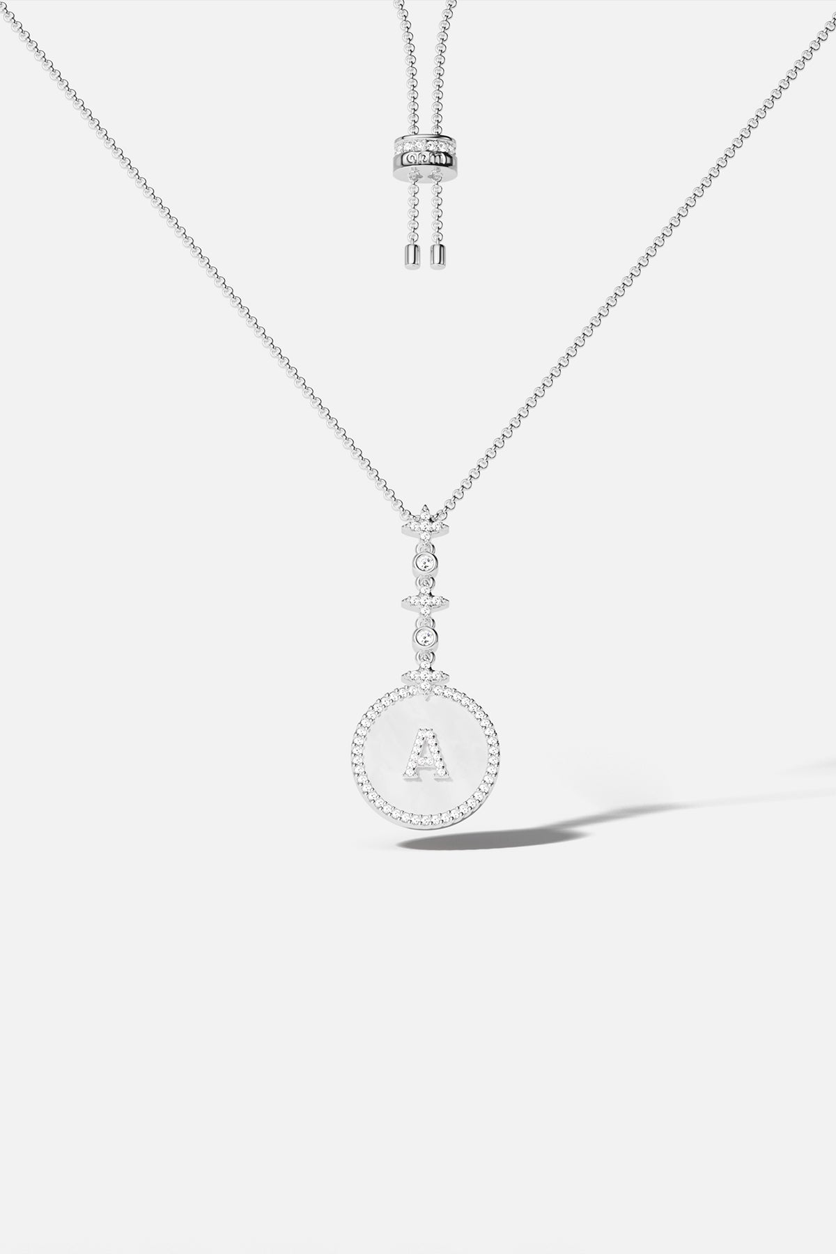 Necklaces APM Monaco, adjustable pendant necklace with pavé-diamond letter A in silver-tone.