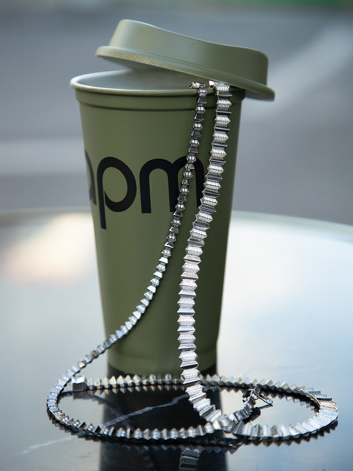 Green cup with a lid and a APM MONACO up and down chain
