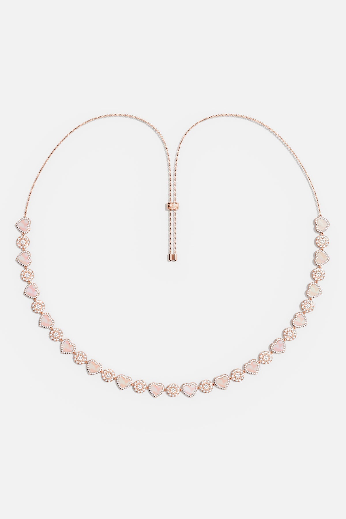 Necklaces APM Monaco. Rose gold tone adjustable necklace with pink nacre heart pendants, separated by small clear stones.