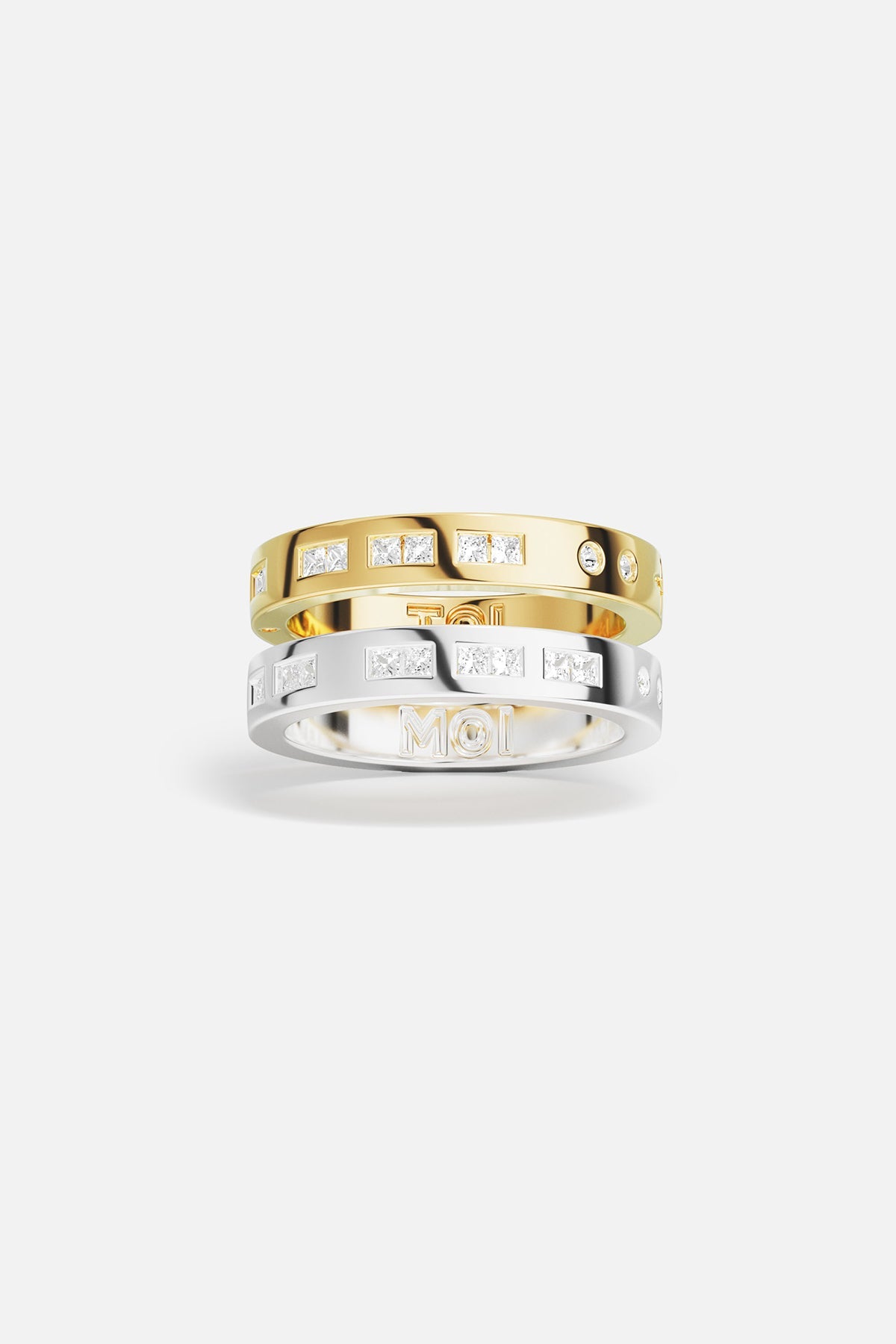 Rings APM Monaco: two stacked rings, yellow gold and white gold, white cubic zirconia, one with MOI engraving.
