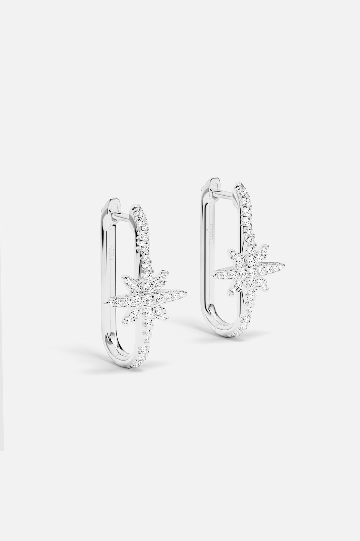 Earrings APM Monaco, silver-tone pair featuring a star-shaped and a U-shaped design.