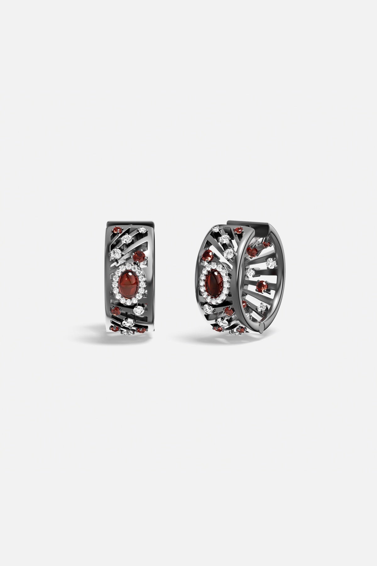 APM Monaco hoop earrings, deep red glow within a smoky rhodium finish, quietly bold.