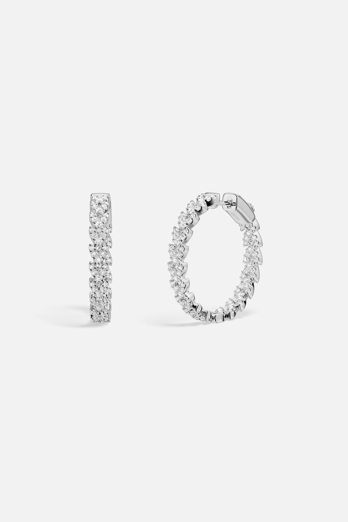 APM Hoop Earrings, a shimmering cascade of brilliance in rhodium finish.