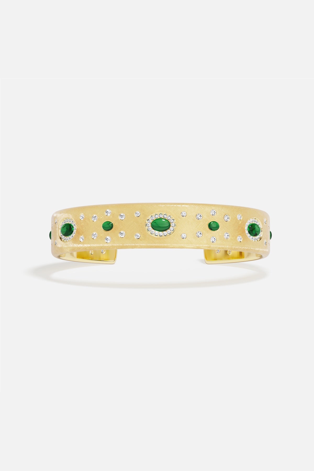 APM Monaco cuff bracelet, golden radiance sprinkled with green accents, quietly regal.