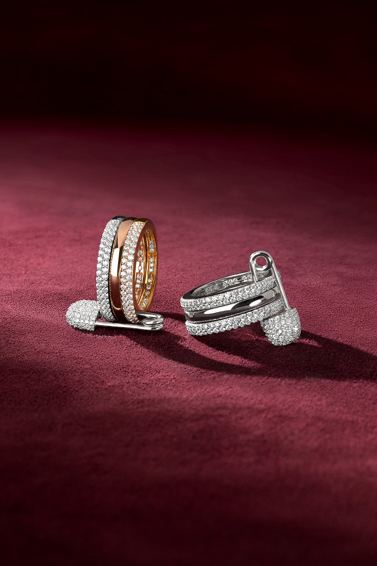 APM Rings shimmering in rhodium finish and rose colors, effortlessly bold on velvet.