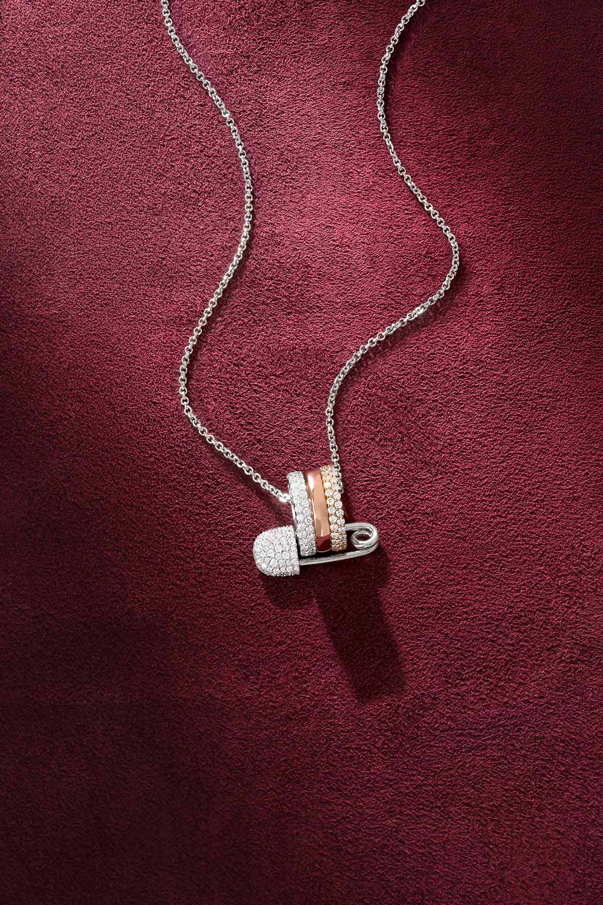 APM Safety Pin Necklace, a playful charm layered in tri-color brilliance.
