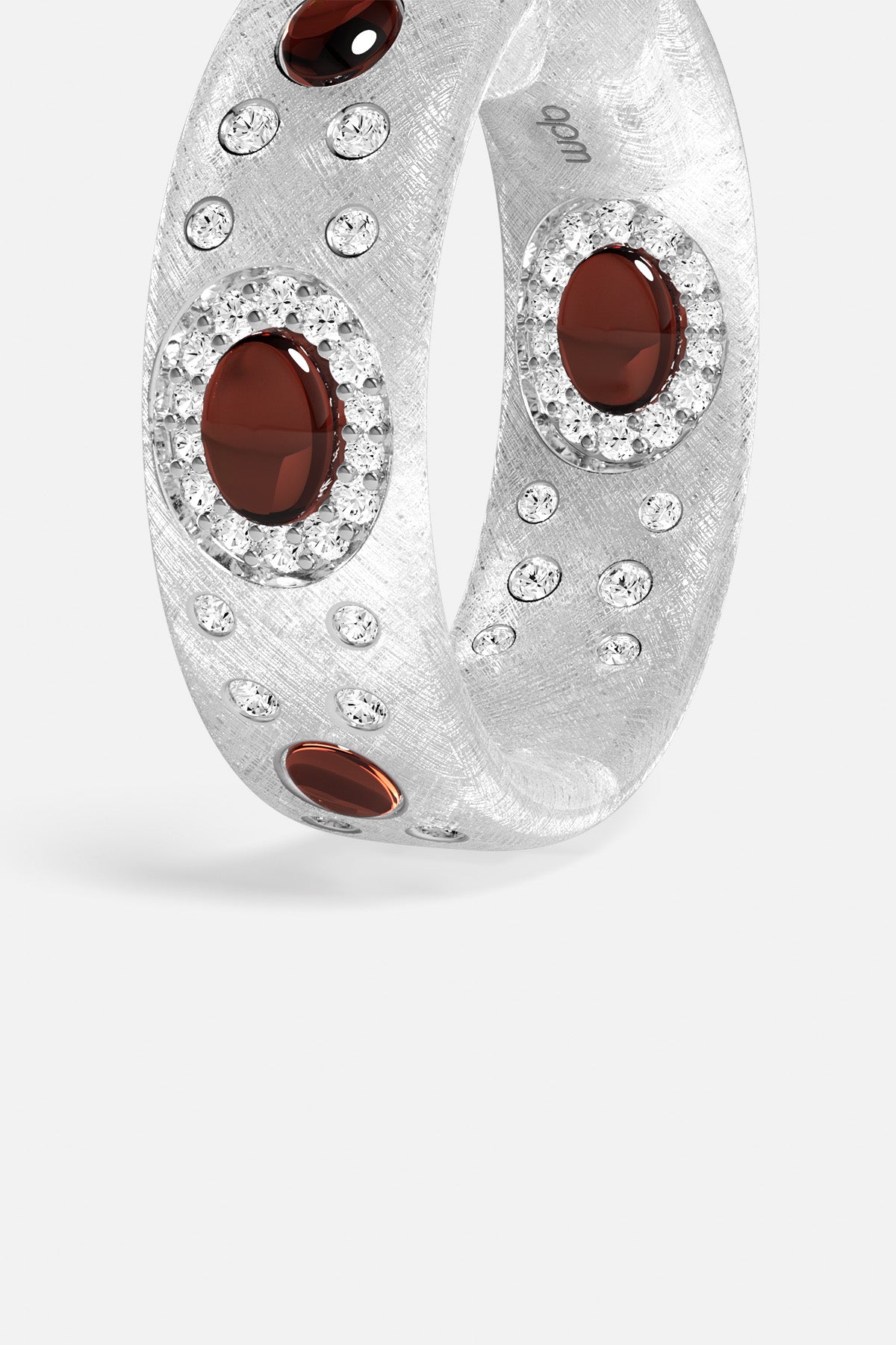 APM Ring in rhodium finish, deep red stones scattered with quiet brilliance.