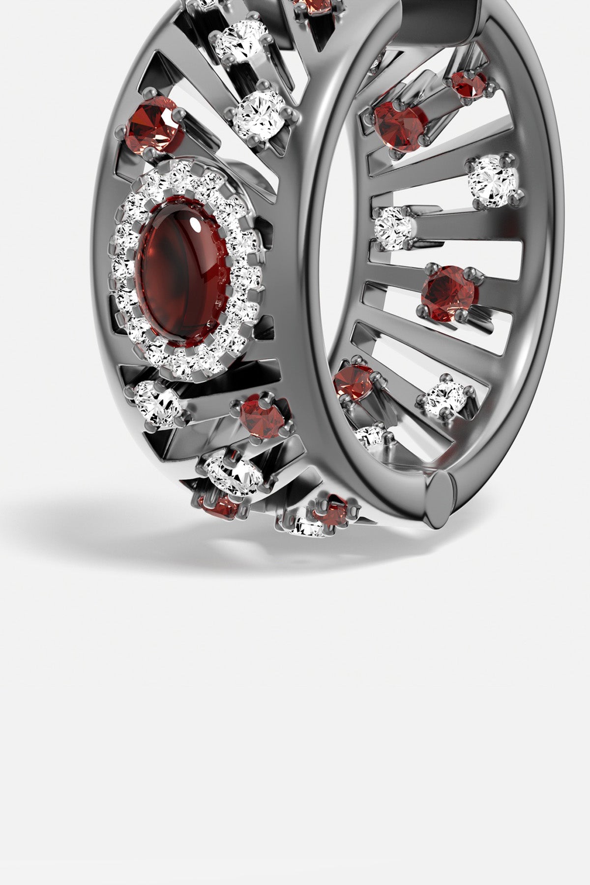 APM Ring in rhodium finish, glowing with deep red and crystalline sparkle.