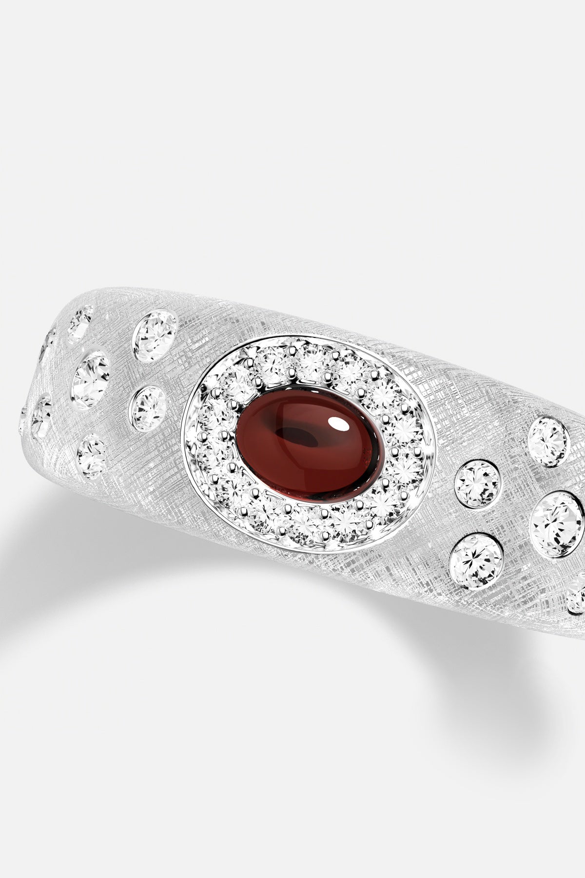 APM Ring, a deep red center framed in radiant sparkle, quietly captivating.