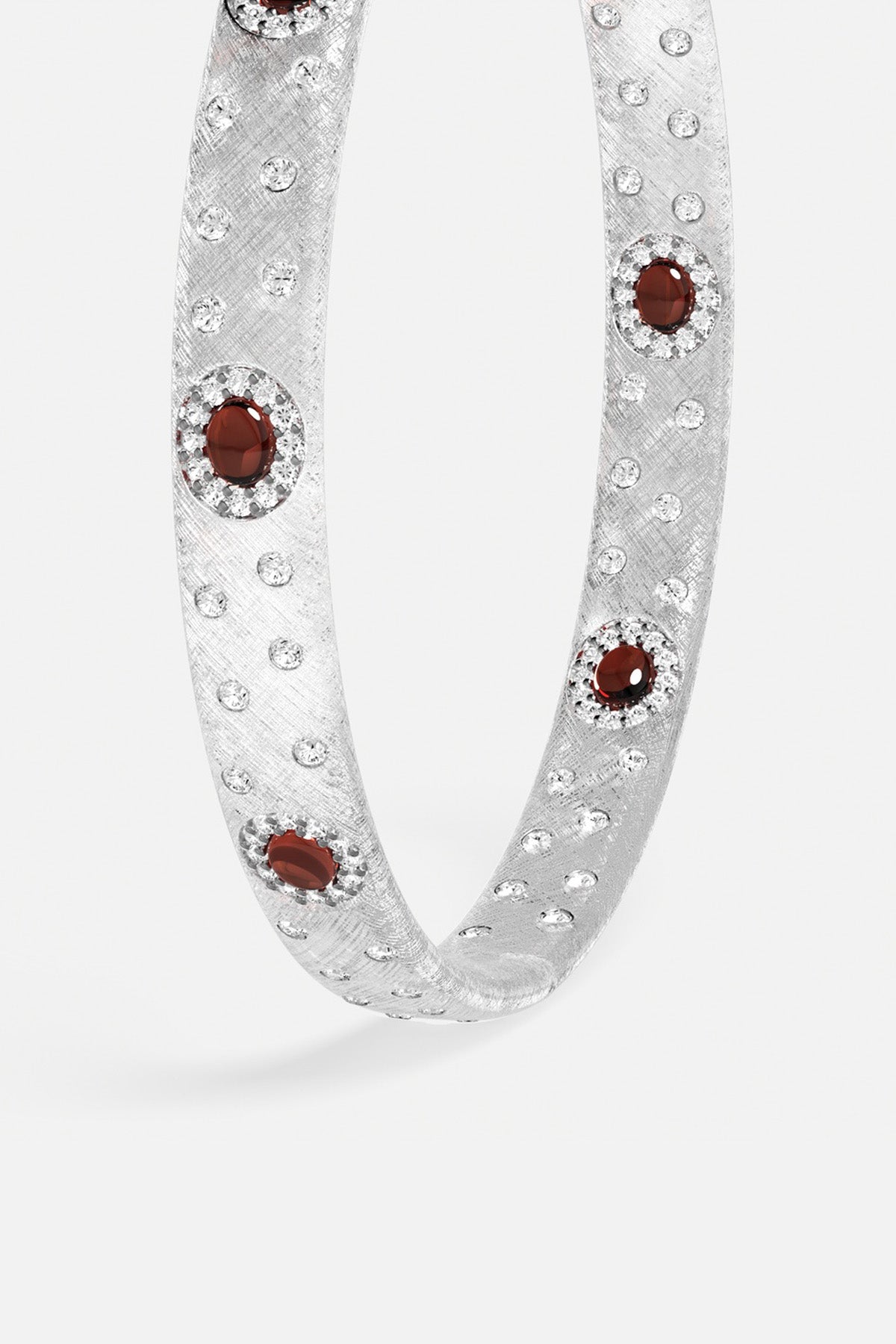 APM Bracelet in rhodium finish, scattered with crimson stones for quiet allure.