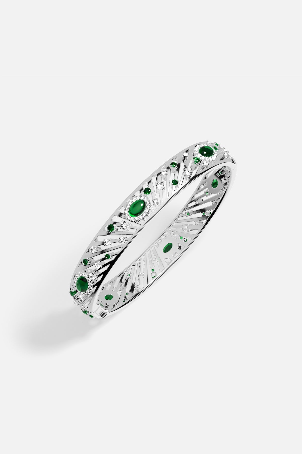 APM Bangle radiating with emerald green stones, a luminous burst of celestial elegance.