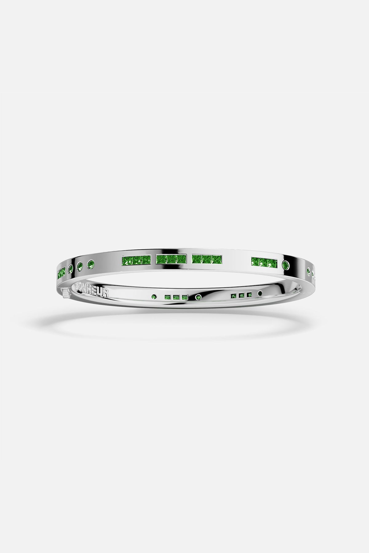 APM MONACO silver bracelet with green stones on a white background