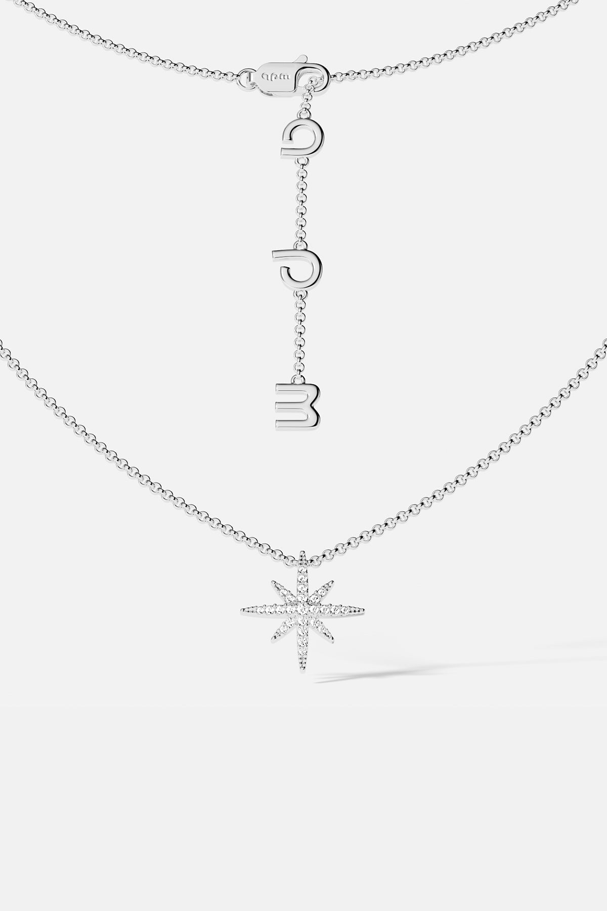 Necklaces APM Monaco, silver star-shaped pendant on a chain with meteorite texture.