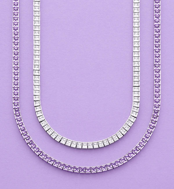 Two APM MONACO torsade necklaces in white and purple on light purple background