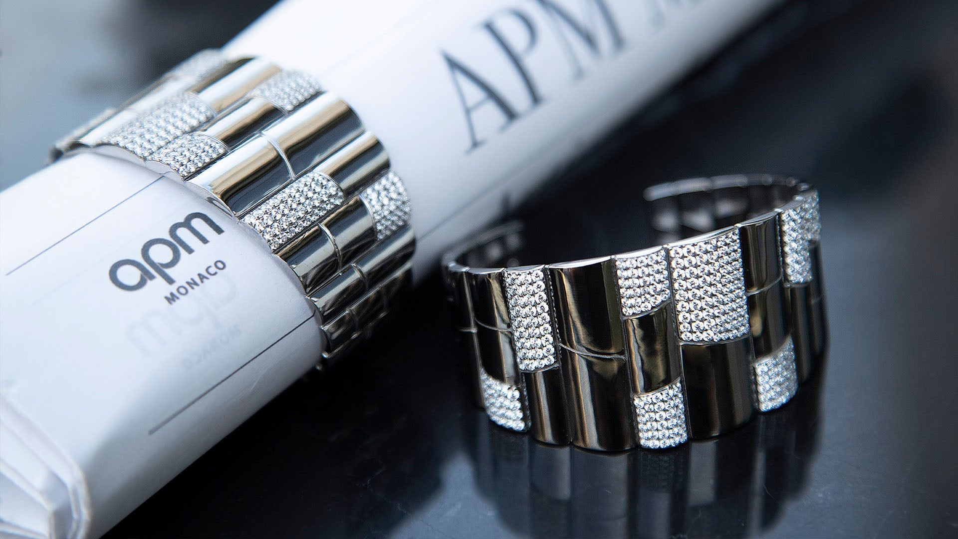 Silver APM Monaco Automne Pave Bangle  on a dark surface