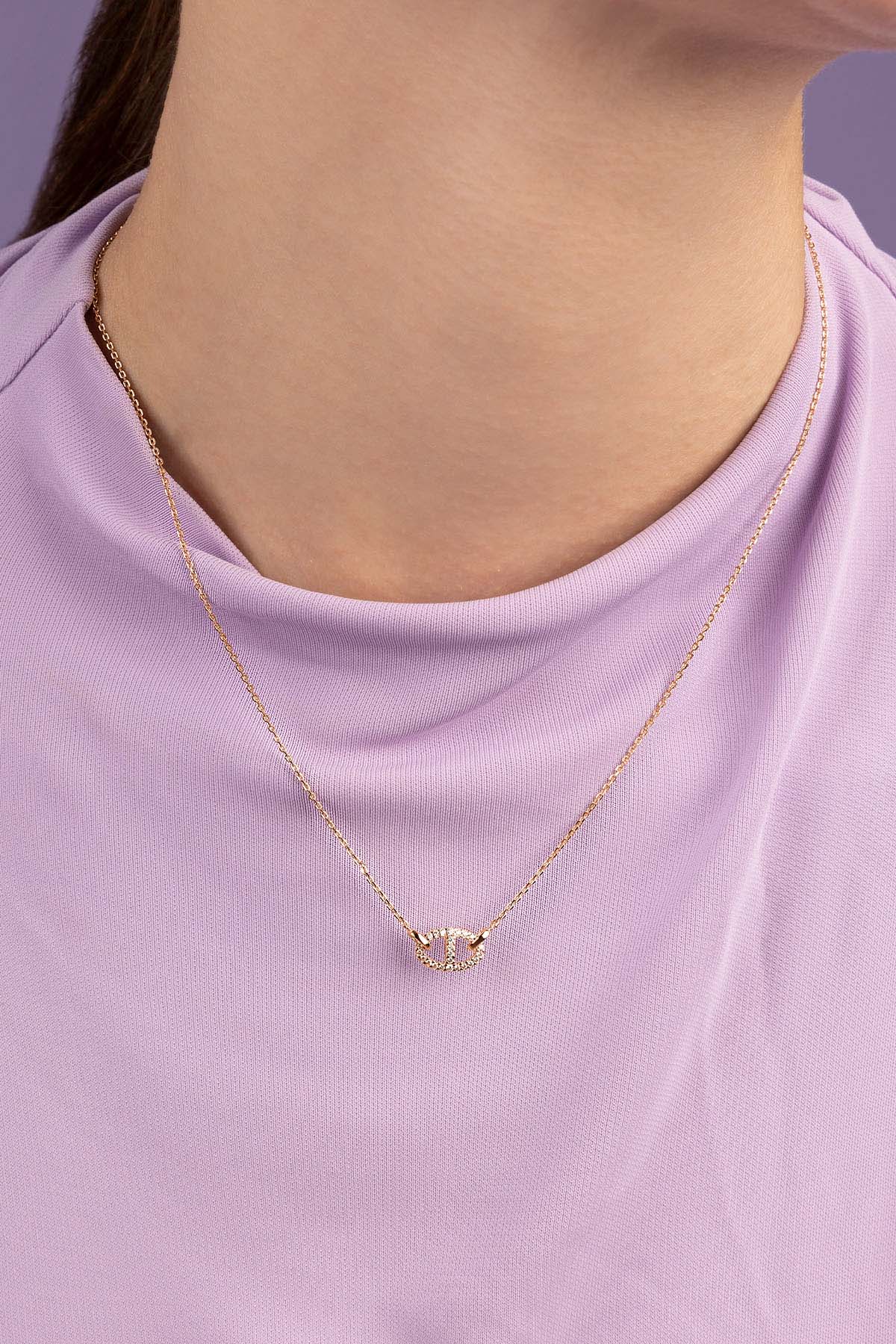 APM MONACO rose gold necklace with unique pendant on a white background