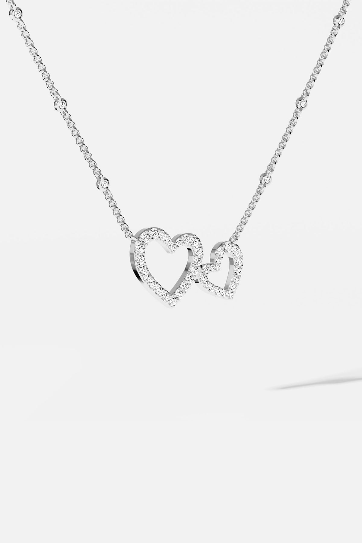 APM MONACO white necklace with heart-shaped pendant on a white background