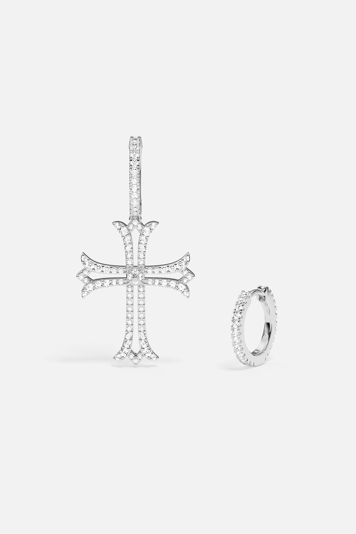 Earrings with cross pendant and hoop earring on a white background