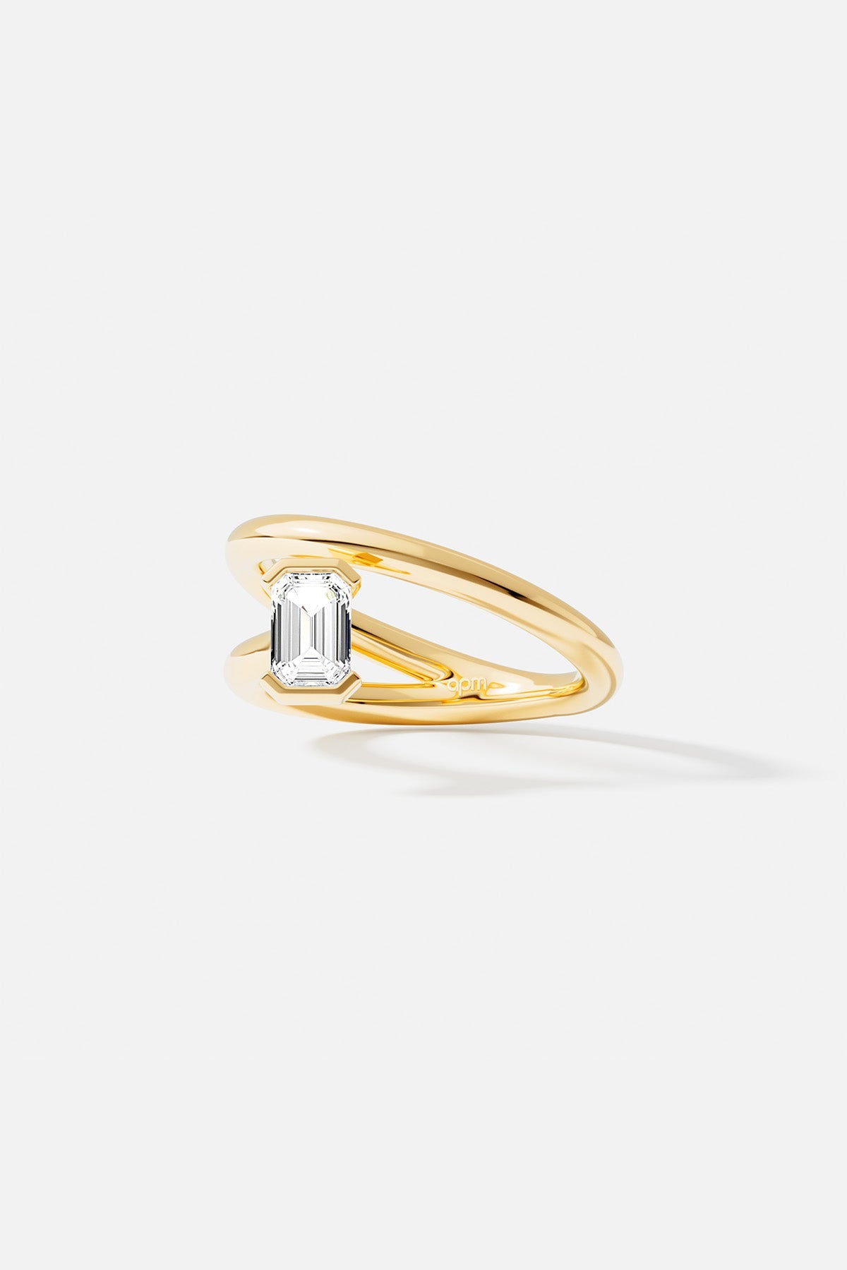 Rings APM Monaco yellow gold ring with an emerald-cut white diamond.