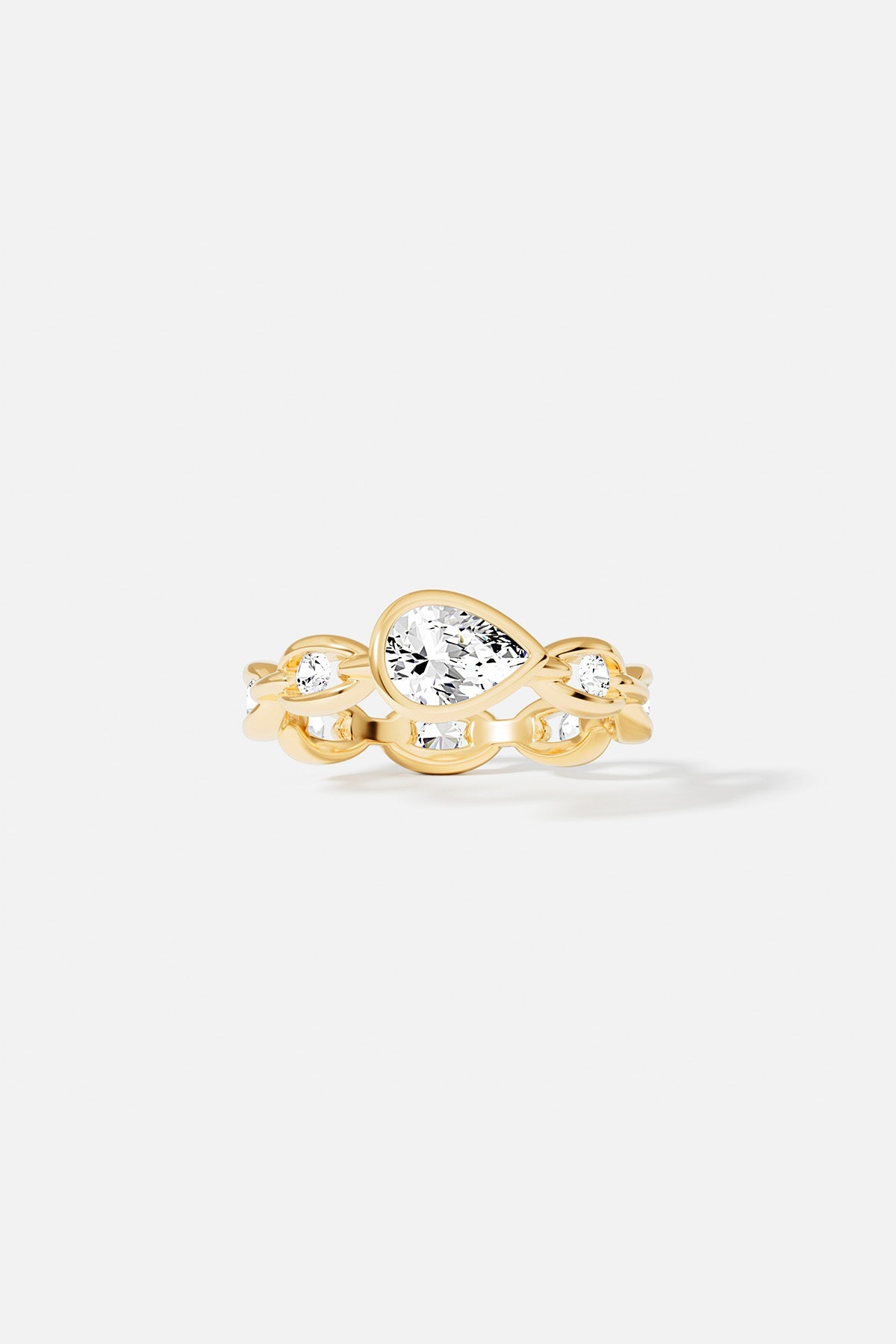 Rings APM Monaco yellow gold chain ring featuring a pear-shaped diamond surrounded by round pave diamonds.