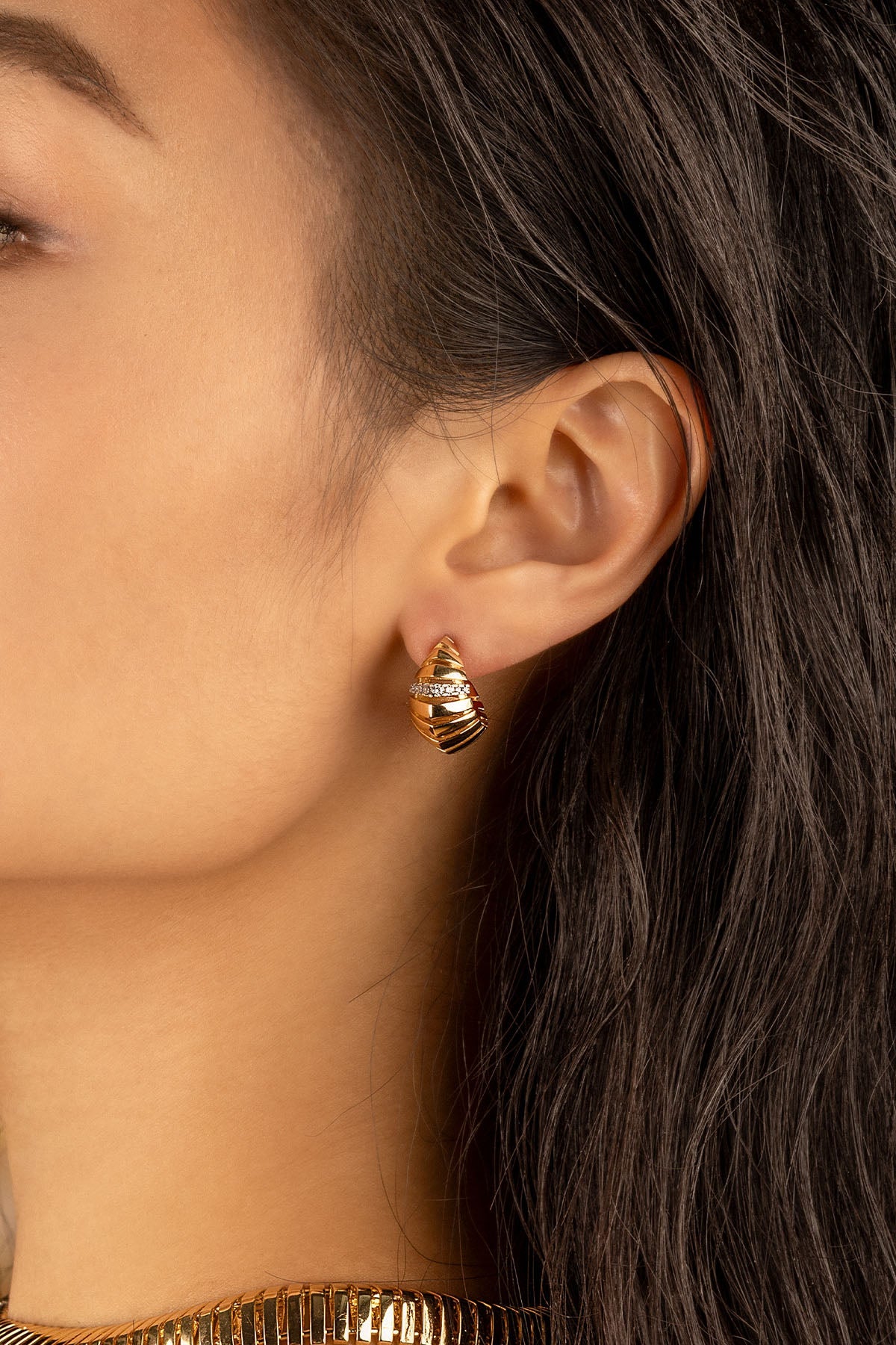 Earrings APM Monaco, yellow gold hoop with pavé white diamonds, sunray motif.