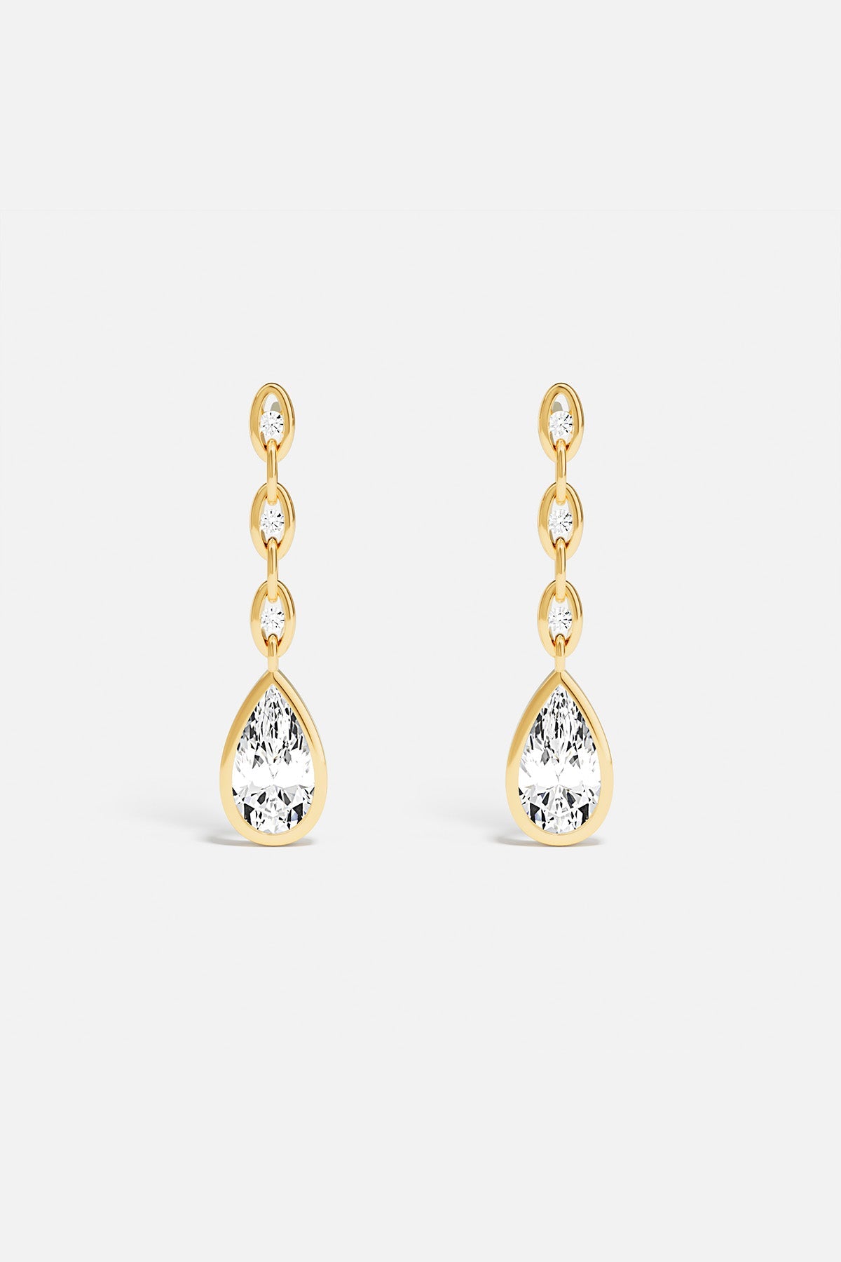 Earrings, APM Monaco: yellow gold chain earrings with dangling teardrop pendants.